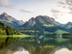 Lake Schwarzsee surrounded by lush mountains near Hotel des Innovations