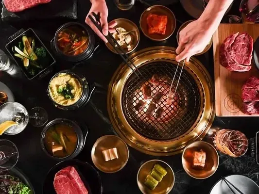 Tabletop grill with meats at Cote Miami, a michelin starred Korean steakhouse