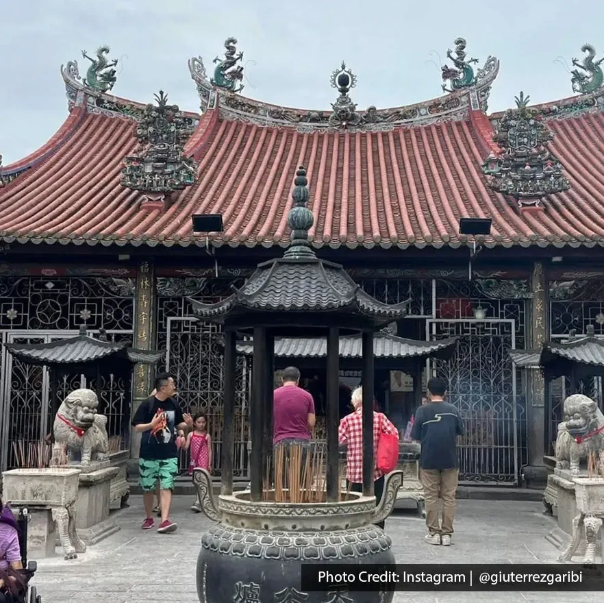 Crowd gathered at Goddess of Mercy Temple with incense burner in George Town Penang.