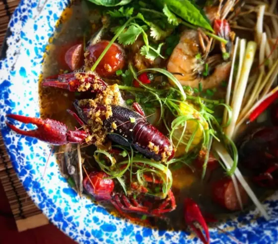     Vietnamese-Cajun dish with fresh herbs and chilies at Phuc Yea in Miami's MiMo neighborhood