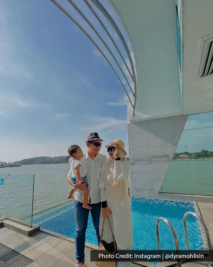Parents and child beside an infinity pool overlooking the sea.