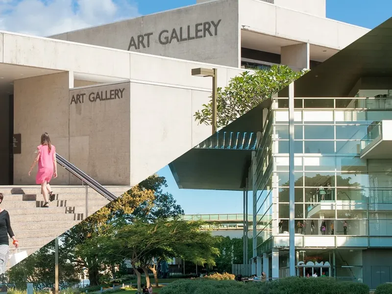 Modern white concrete art gallery building with glass walls, outdoor stairs, and landscaped gardens at QAGOMA.