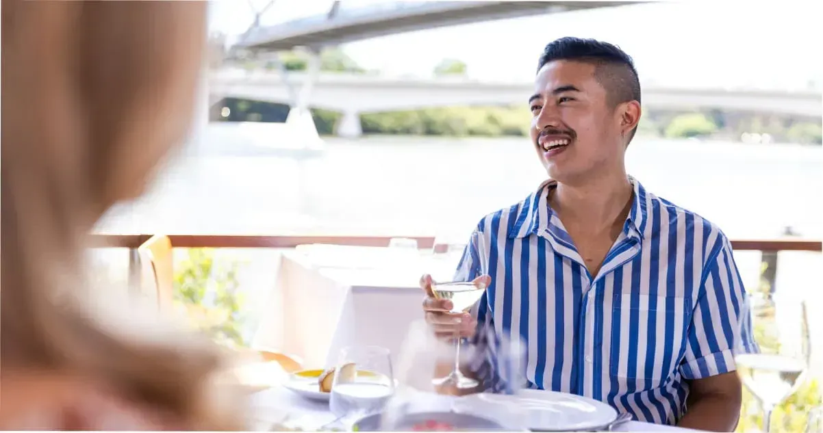 A man smiling while dining at OTTO Ristorante in South Bank, Brisbane
