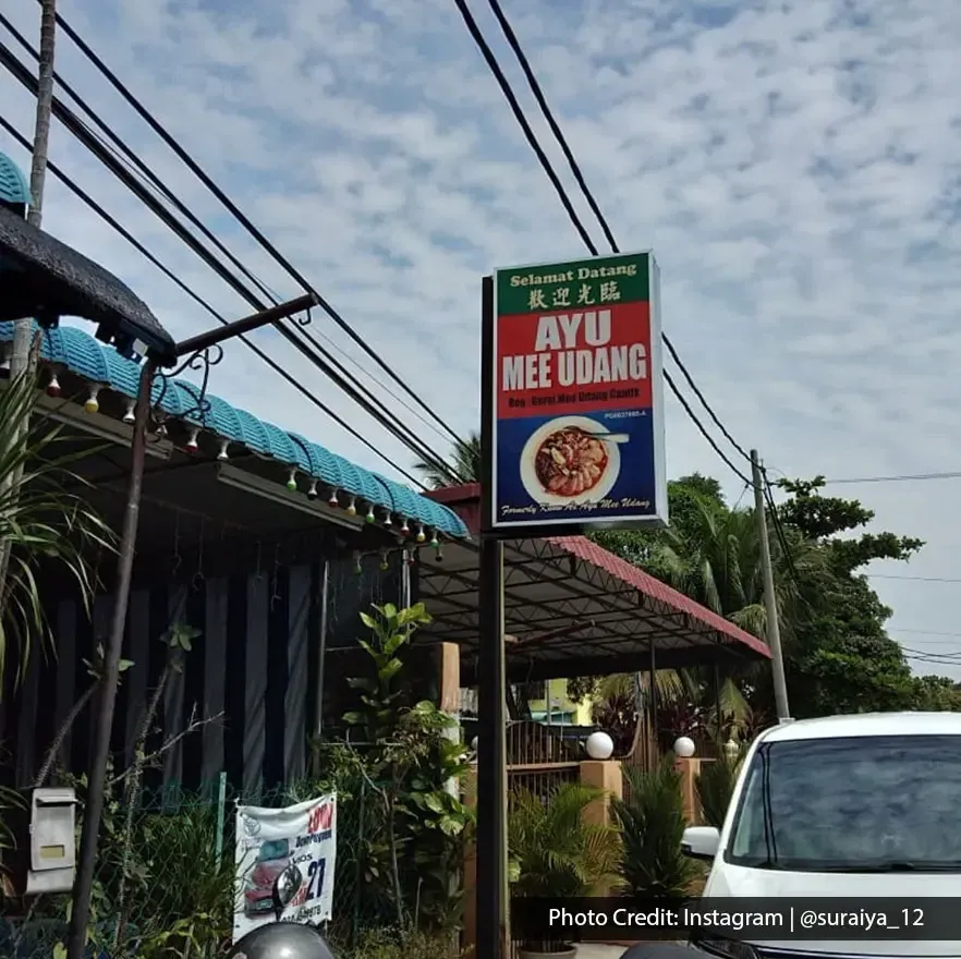 Street view of Ayu Mee Udang restaurant signboard under blue sky