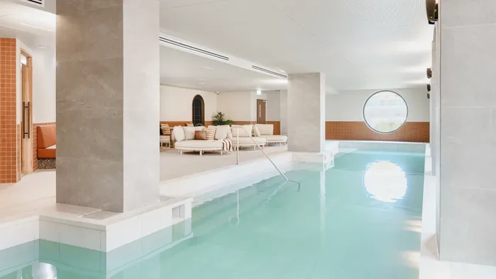 Spacious indoor pool with lounges.