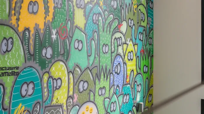 Bright and colorful cactus mural on a wall at Appart’Hôtel Hévéa.