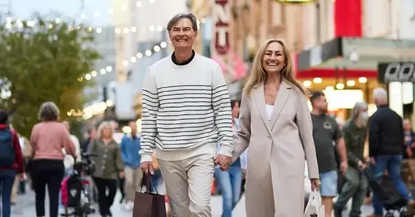 couple holding hands and smiling along rundle mall adelaide