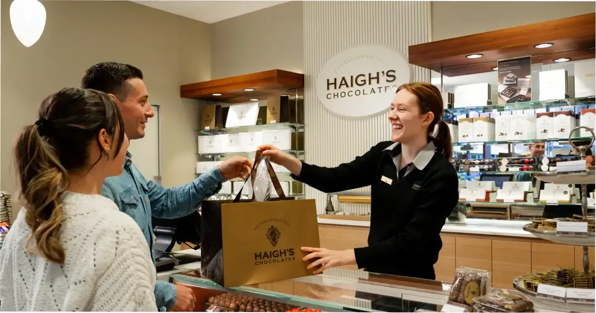 A couple purchasing some chocolate from Haigh’s Chocolates at Adelaide Central Market.