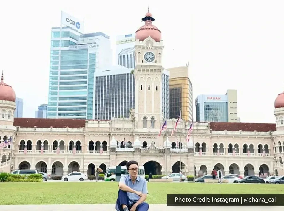 Visitor posing at Dataran Merdeka with Sultan Abdul Samad Building behind
