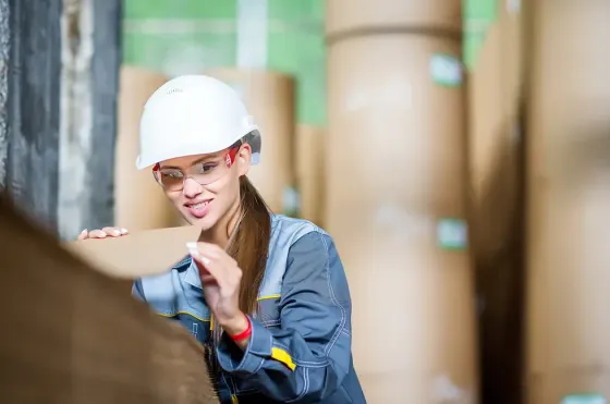 A woman inspecting a piece of recycled paper - Grand Lexis Port Dickson