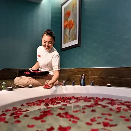 A professional staff preparing bathtub filled with rose petals in luxury hotels and resorts in Malaysia - Lexis MY 