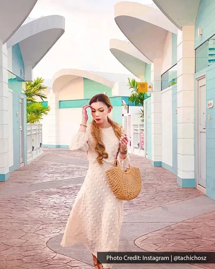 A woman in a beautiful dress posing for a picture at the luxury beach resort - Lexis MY
