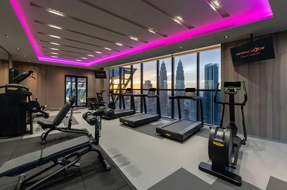 A fully equipped gym room offering a stunning city view - Imperial Lexis Kuala Lumpur
