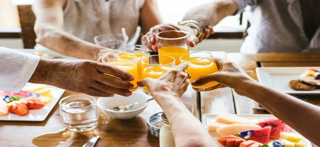 A group of people cheers over a delightful breakfast in Canmore.