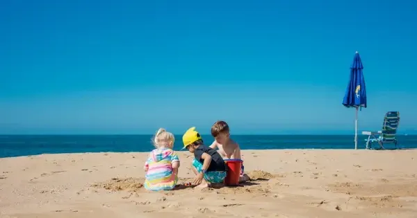 Children play in the sand on a pristine beach off Townsville