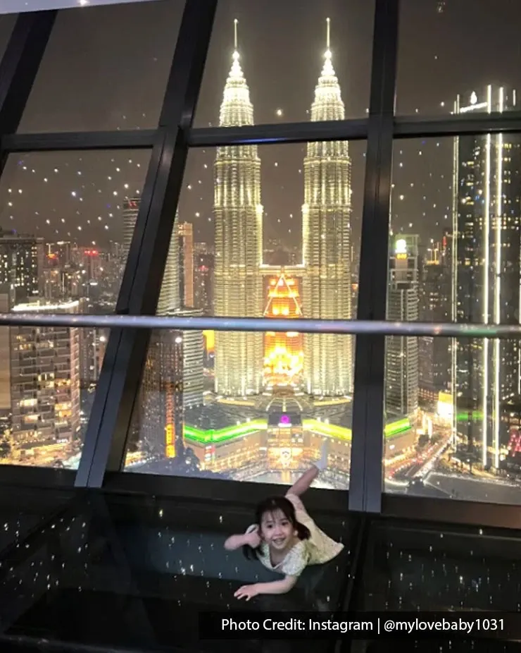 Child posing at Sky Deck overlooking the Petronas Twin Towers