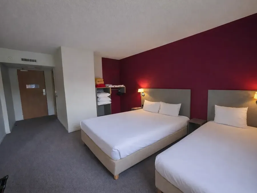 Chambre triple familiale avec deux lits doubles et décoration moderne à l'Hôtel Les Bruyères à Castets.