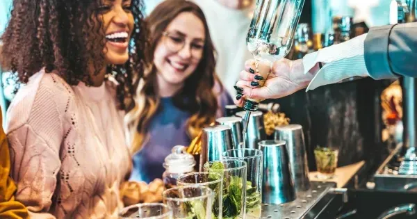 Guests enjoying cocktails at a Christmas party bar