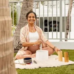 Woman doing Yoga & Sounds Healing Meditation at The Savoy Hotel & Beach Club