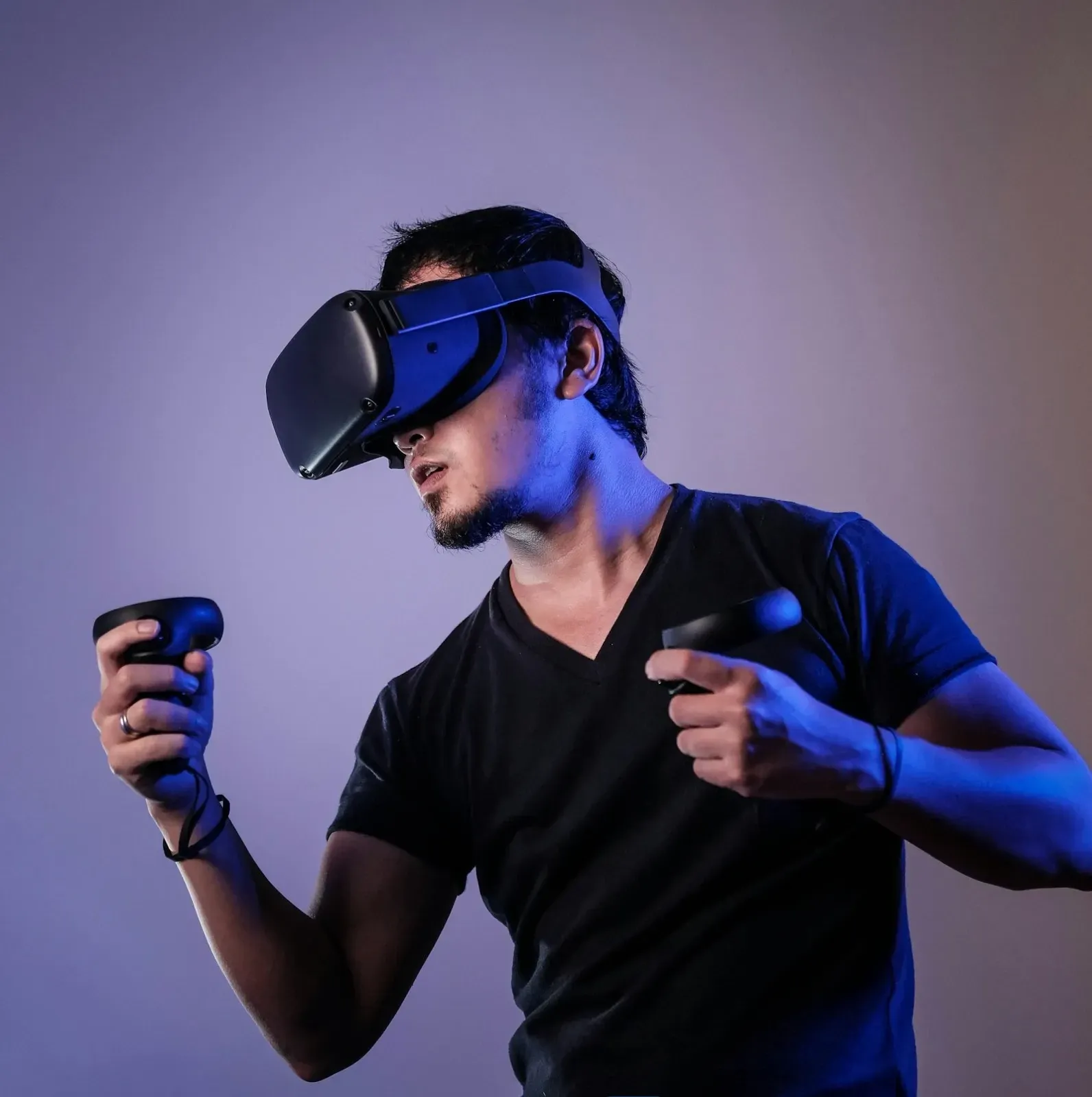 A visitor wearing a virtual-reality headset, bathed in colored light