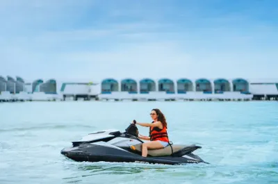 Woman wearing sunglasses enjoying jet ski water sports - Lexis Hibiscus Port Dickson