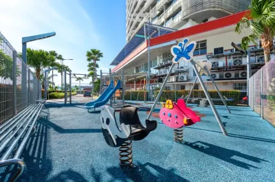 Outdoor playground with swings and spring-mounted animal toys – Lexis Hibiscus Port Dickson