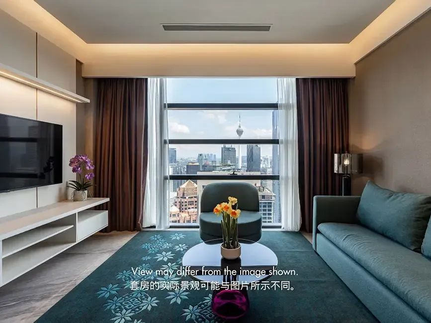 Modern living room in a 2-bedroom residential suite with floor-to-ceiling windows and KLCC skyline views.