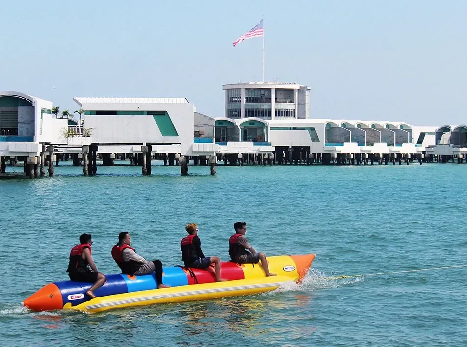 A group of people playing the banana boat - Lexis Hibiscus