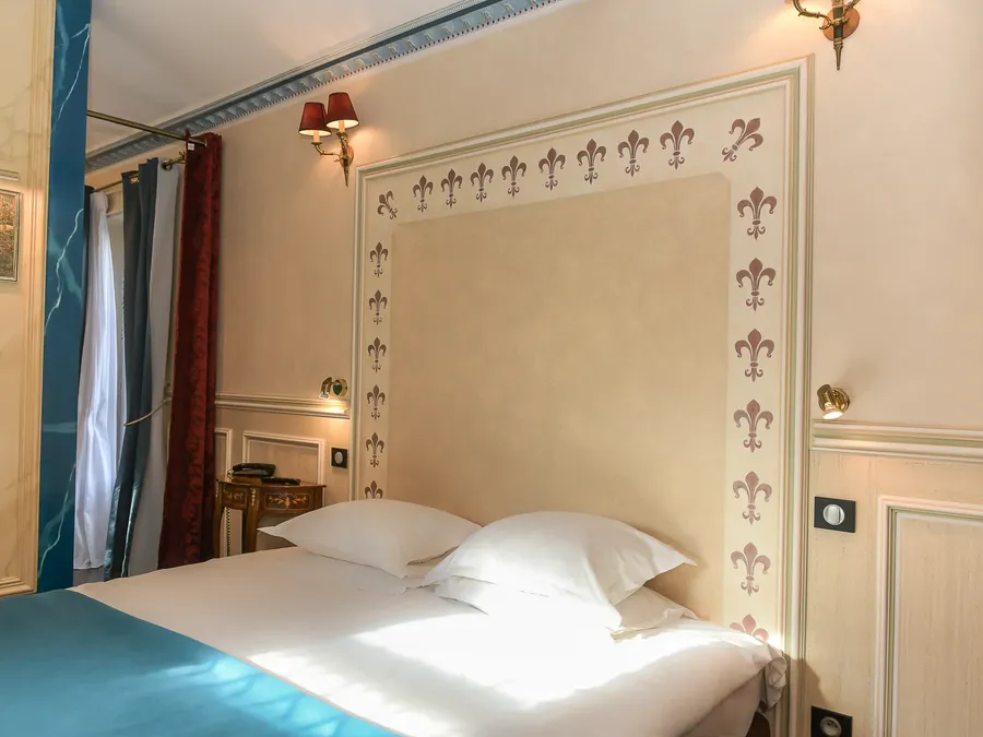 Suite Royale élégante avec lit et fleurs de lys au mur à Hôtel Villa Aultia, Ault.