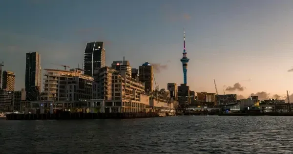 Sun sets over the Auckland skyline from a harbourside vantage 