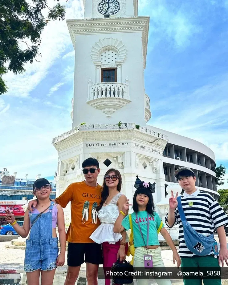 Group of visitors taking picture together at Queen Victoria Memorial Clock Tower.