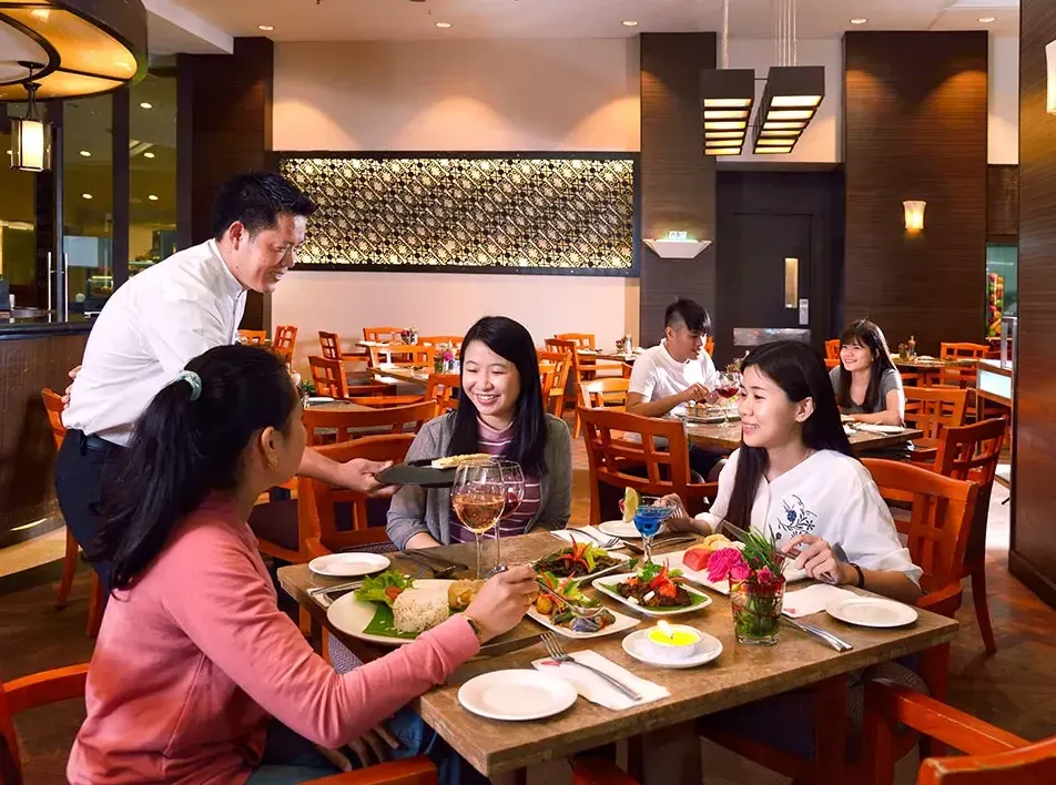 A group of friends enjoying meals together during their vacation - Lexis MY
