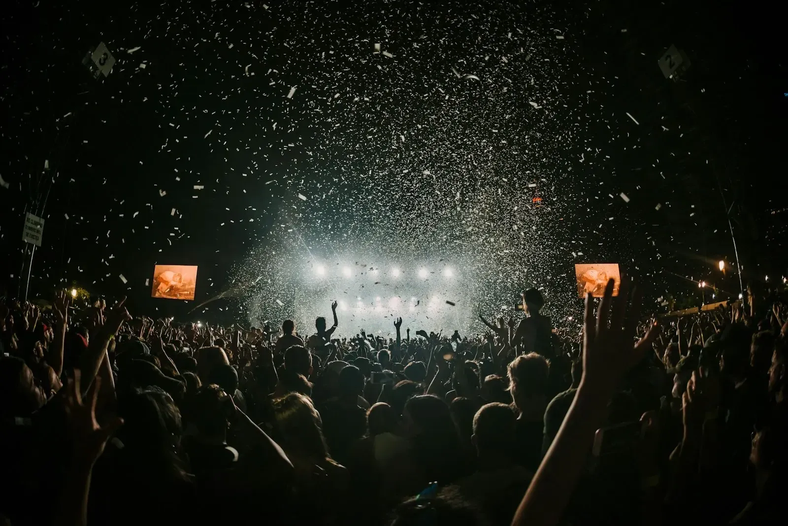 Confetti falling over a festival crowd at night