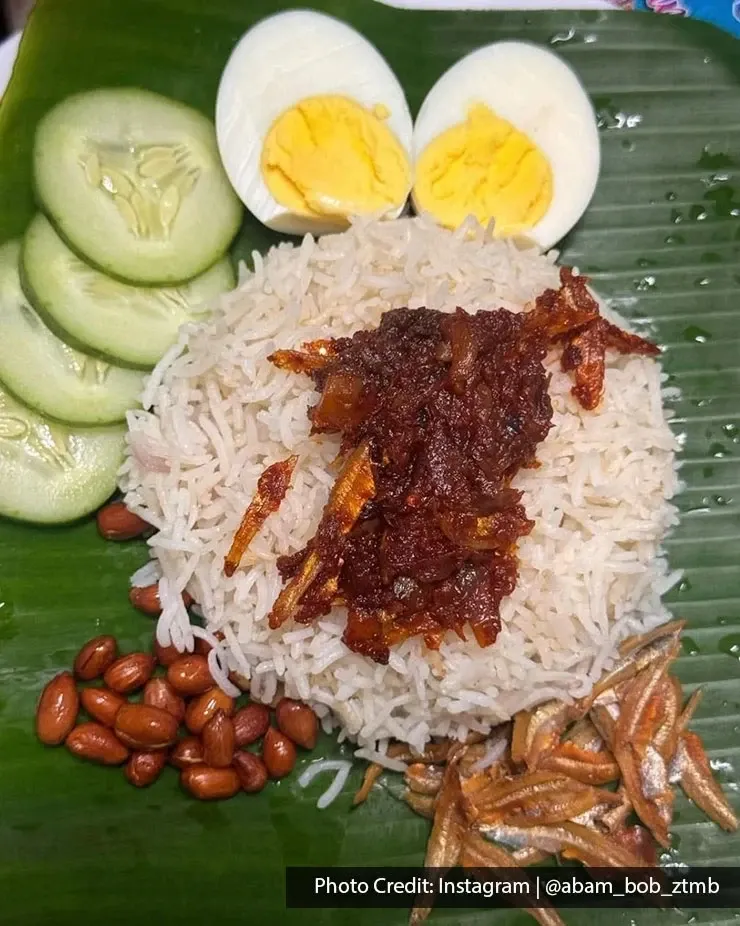 Nasi lemak with sambal, anchovies, peanuts, egg and cucumber.