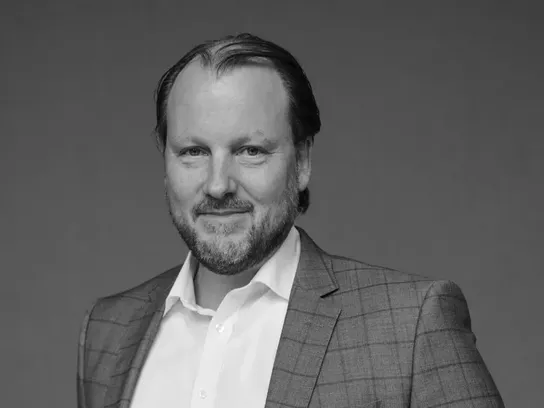 Professional portrait of Gregor Schertler in a suit, photographed against a neutral backdrop for Flemings Hotels