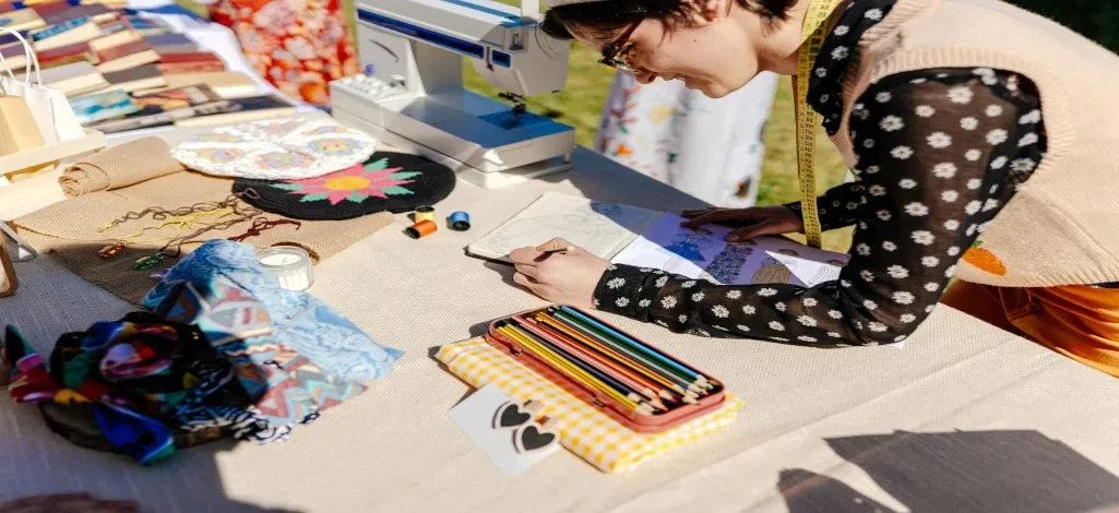 A vendor at a craft fair in Canmore shows off their designs to shoppers.