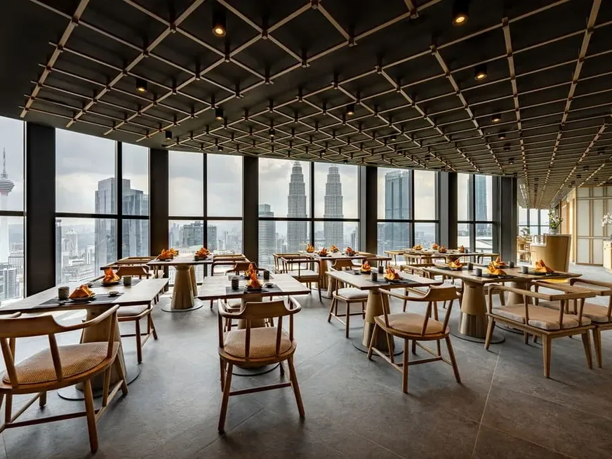 Modern Japanese dining hall at UMI Japanese Restaurant with stunning views of the Petronas Twin Towers.