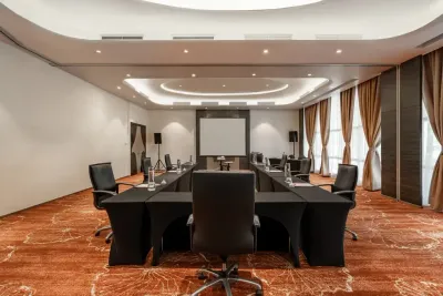 Meeting room setup with black chairs and presentation screen – Lexis Hibiscus Port Dickson