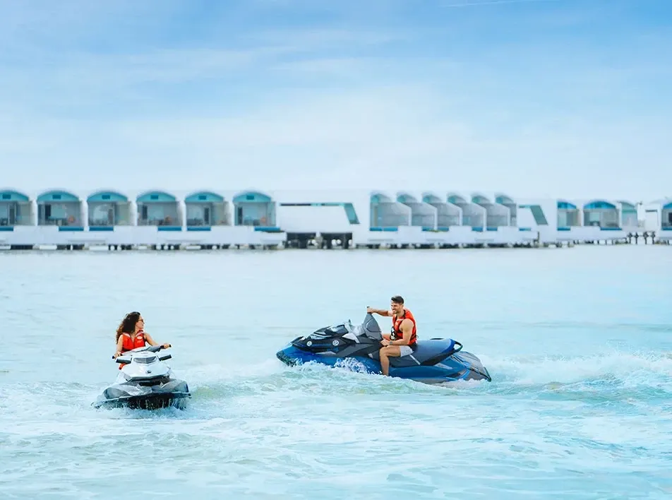 A couple playing jet ski on sea - Lexis Hibiscus