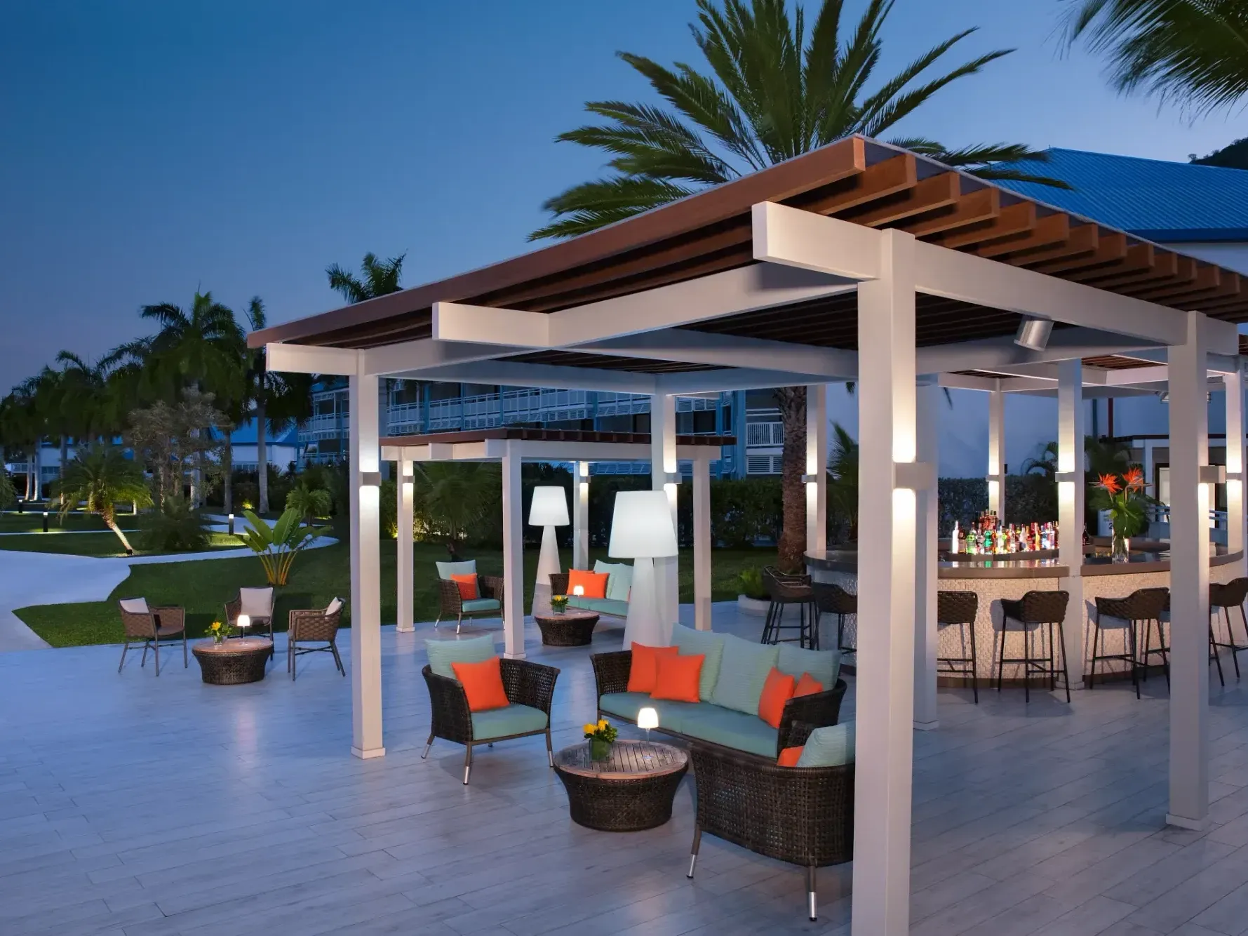 Barracuda Lobby Bar with lounge seating and palm trees at Saint Martin Beach Resort & Spa, a St. Martin all inclusive resort