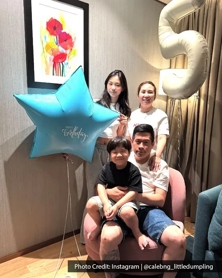 Family photo at a hotel room taking birthday shot together.