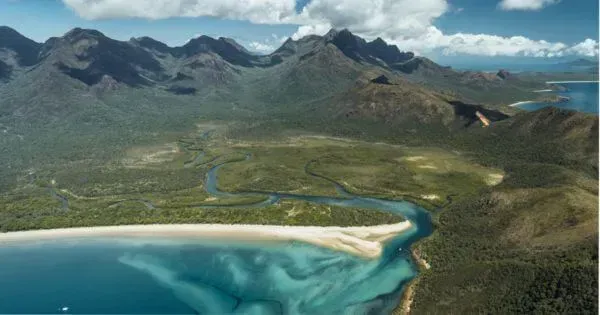 An aerial shot of the ocean, beaches, and forest on Hinchinbrook Island, Townsville
