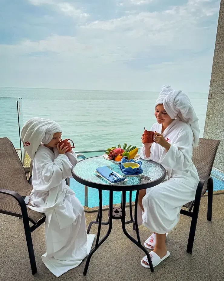A mother and daughter relaxing by the private pool at the family-friendly beach resort - Lexis MY