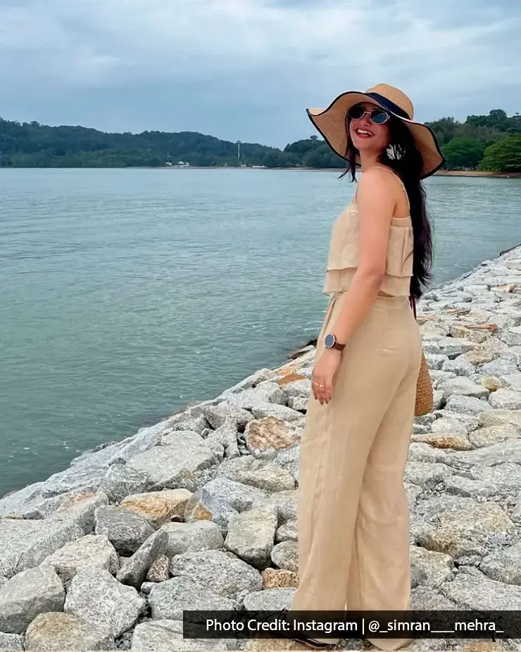 A lady standing by the seashore, posing for a picture during her relaxing holiday - Lexis MY