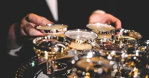 Hands reaching for a tray of cocktails