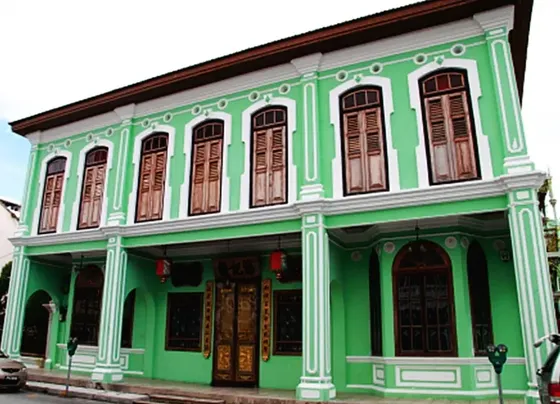 The Pinang Peranakan Mansion, featuring a green exterior with white trim and windows - Lexis Suites Penang