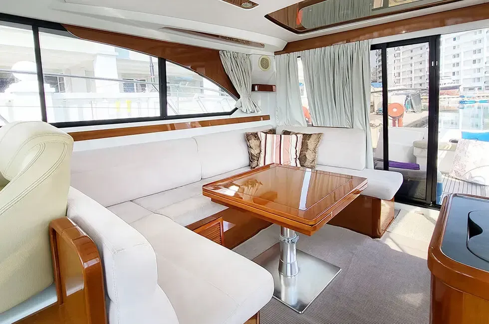 Interior view of a boat featuring a cozy couch and a table - Lexis Hibiscus Port Dickson