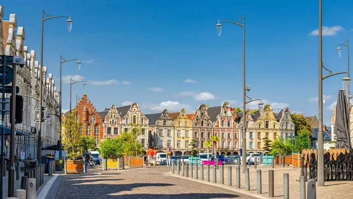 Cobblestone street with historic buildings in Calais at The Originals City Hotel du Parc Gravelines Gravelines.