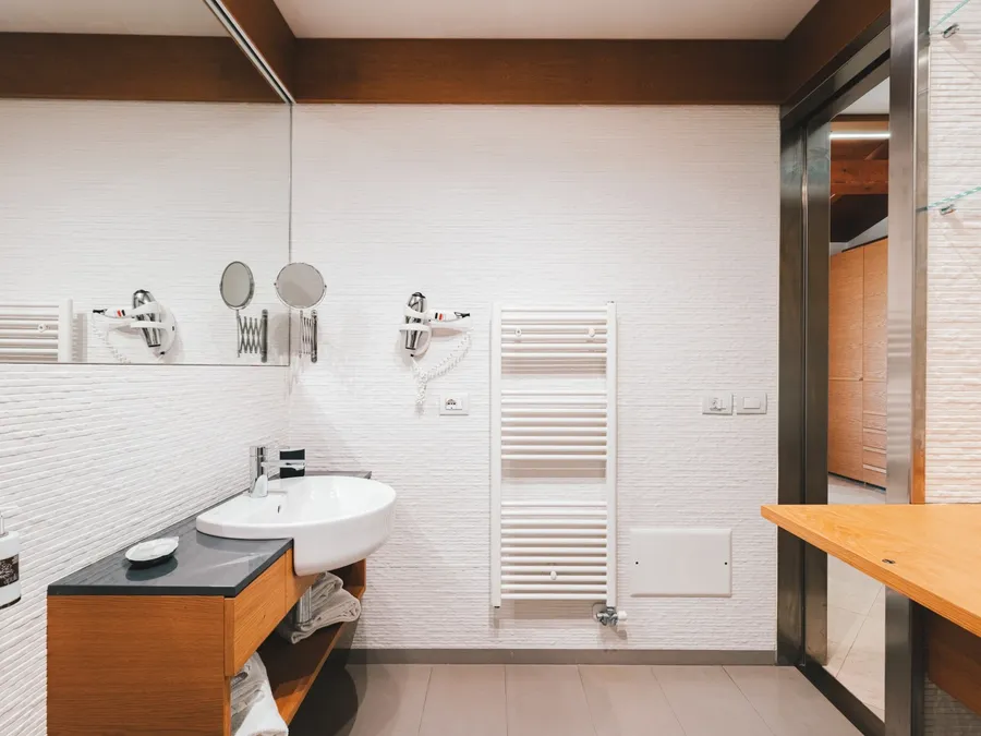 Salle de bain élégante avec lavabo et sèche-cheveux au Masseria Stali à Caprarica di Lecce.