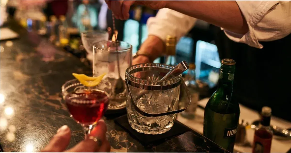 A bartender mixes a cocktail at an Adelaide cocktail bar